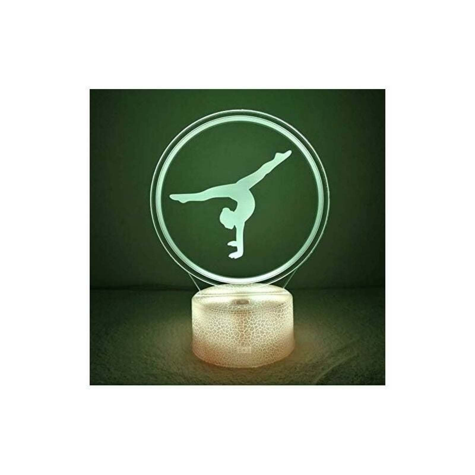 Eine grüne LED-Lampe mit einer Acrylscheibe zeigt die Silhouette einer Turnerin bei einem Handstand.