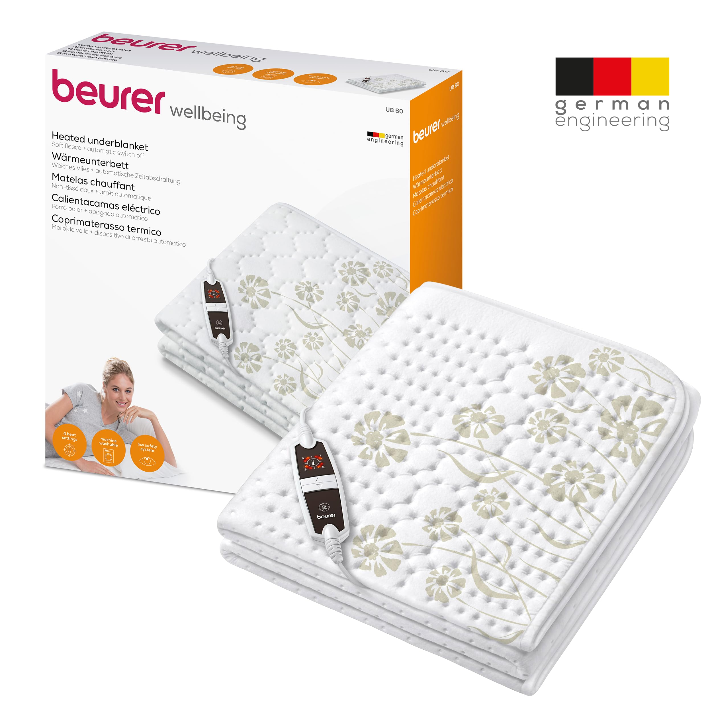 Scatola coprimaterasso termico Beurer UB 60 con coperta bianca piegata a fiori e telecomando.