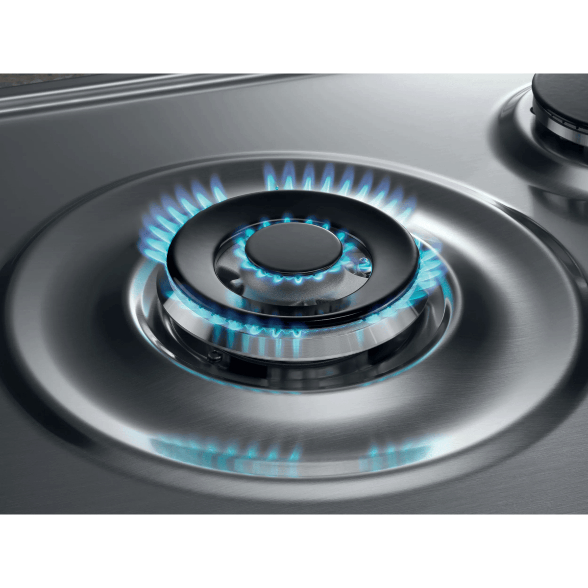 A stainless steel gas hob with a burning blue flame on the main burner.