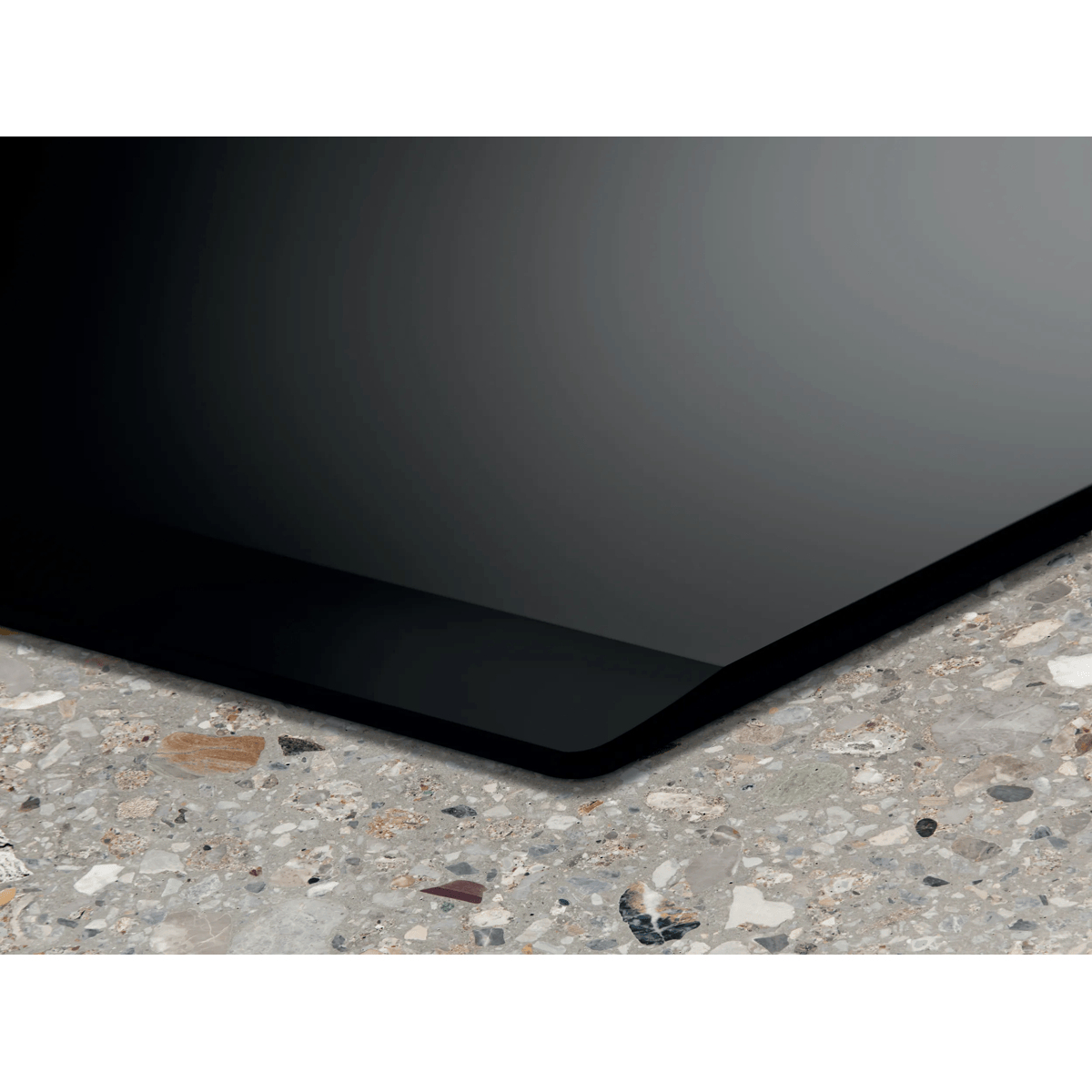 Black glossy plate on a gray marble-patterned surface.
