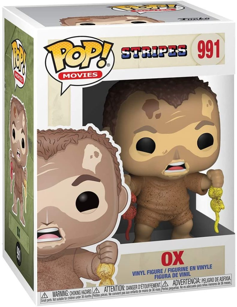 Funko Pop Figur von Ox aus Stripes in einer Schachtel, mit Schlamm bedeckt und kleinen gelben und roten Objekten.