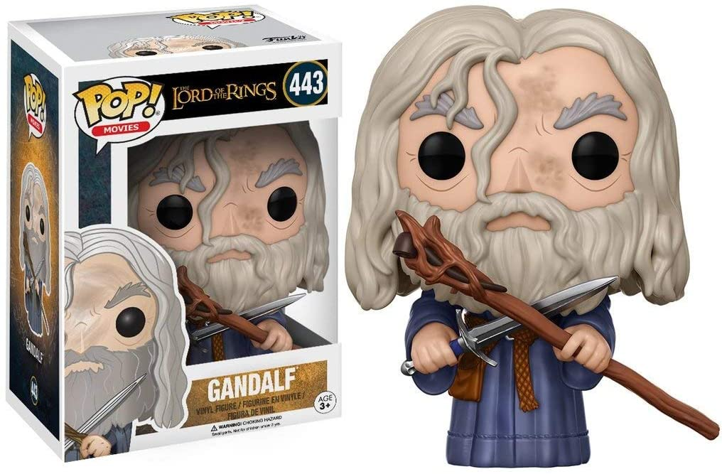 Figurka winylowa Gandalf Funko Pop z laską i mieczem obok pudełka.