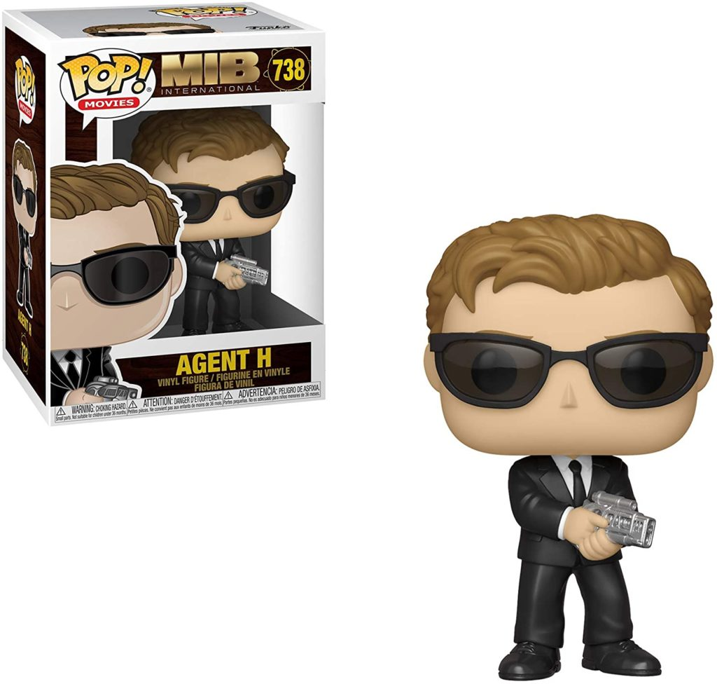Figurine en vinyle Funko Pop Agent H en costume noir avec des lunettes de soleil et une arme, près de sa boîte.