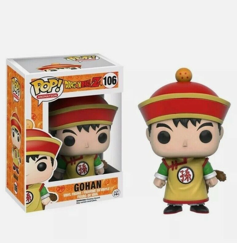 Una statuetta Funko Pop di Gohan con cappello rosso e vestito giallo accanto alla sua scatola.