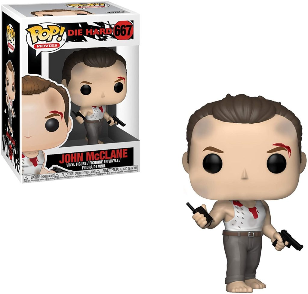 John McClane Funko Pop Figur mit blutigem Unterhemd und Waffe, neben ihrer Verpackung.