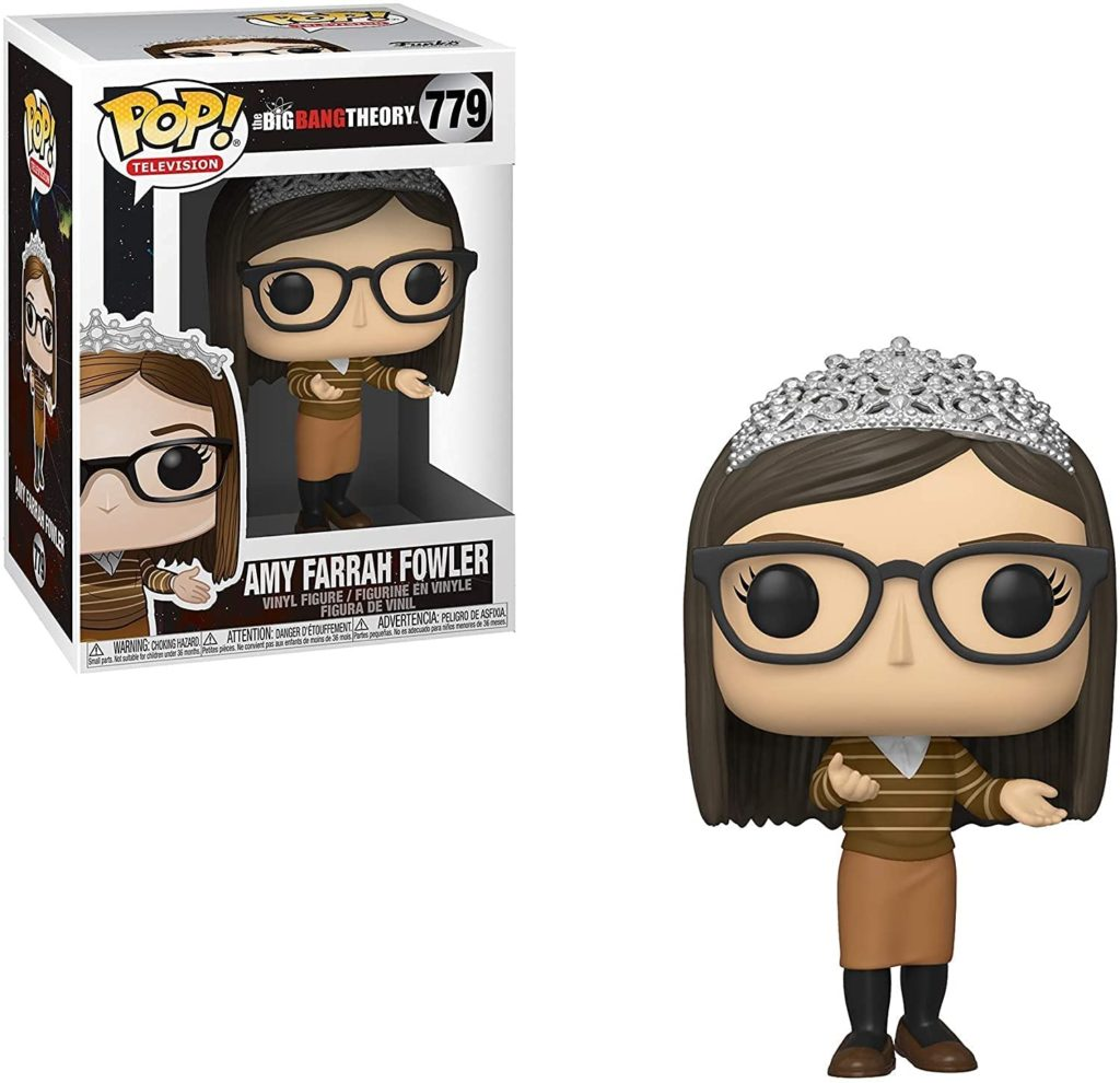 Amy Farrah Fowler Funko Pop Figur mit Tiara, Brille und gestreiftem Oberteil neben ihrer Verpackung.