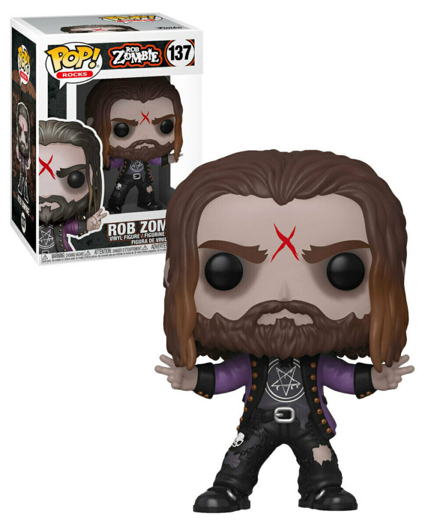 Eine Rob Zombie Funko Pop Figur mit rotem X auf der Stirn steht vor der Verpackung.