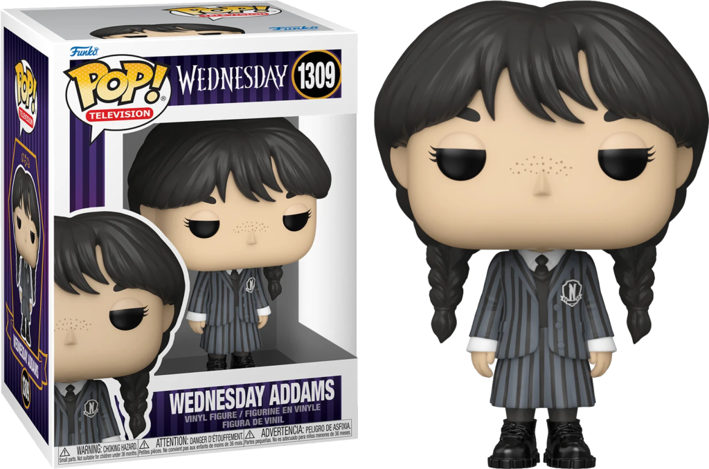 Wednesday Addams Pop-Figur in schwarz-grauem Schlußanzug mit Zöpfen neben ihrer Verpackung.