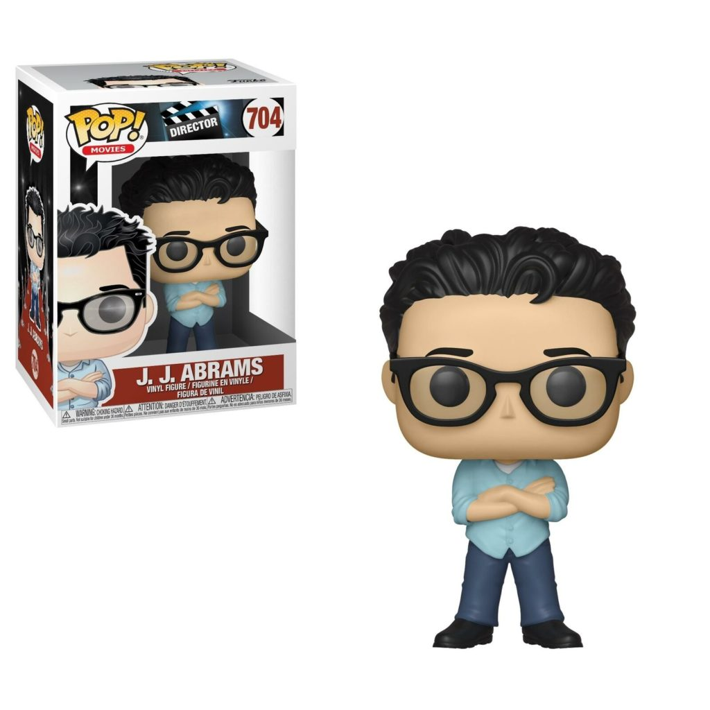 Eine Funko Pop-Figur von J.J. Abrams mit Brille und blauer Hemd, stehend neben der entsprechenden Verpackung.