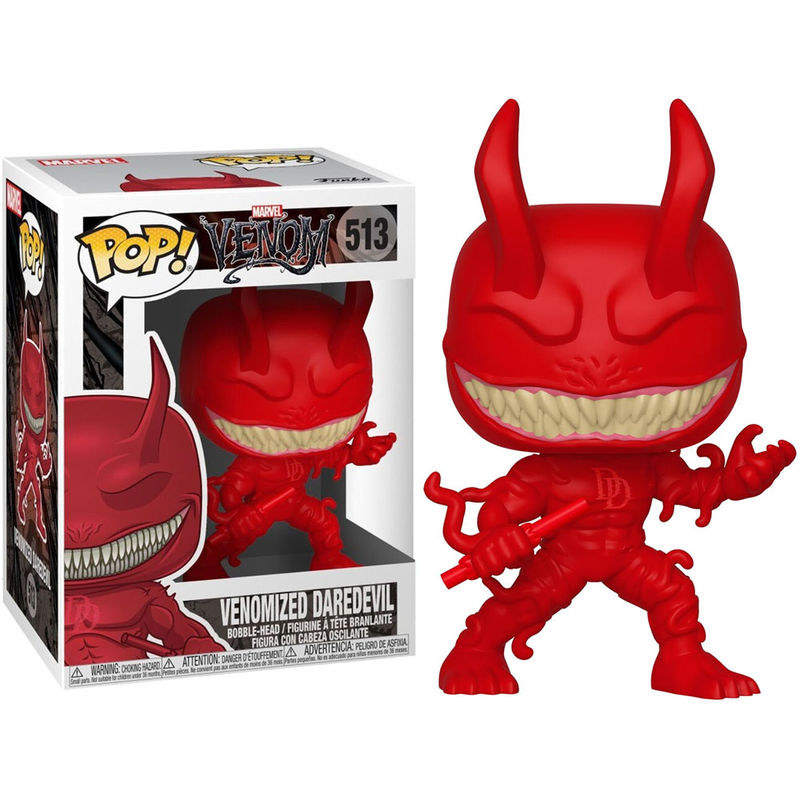 Venomisiertes Daredevil Funko Pop Figur in Rot mit Hörnern und weißer Zahnreihe, stehend neben der Produktverpackung.