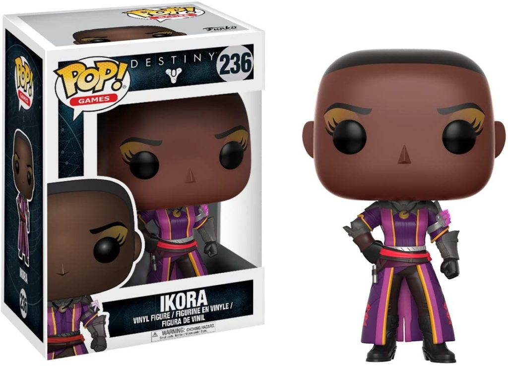 Ikora Vinyl-Sammelfigur aus dem Videospiel Destiny, stehend in violetter Rüstung, mit Verpackungsbox.