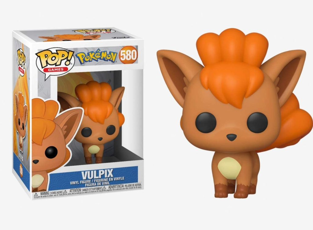 Eine Vulpix Funko Pop Vinyl-Figur neben ihrer beschrifteten Schachtel vor weißem Hintergrund.