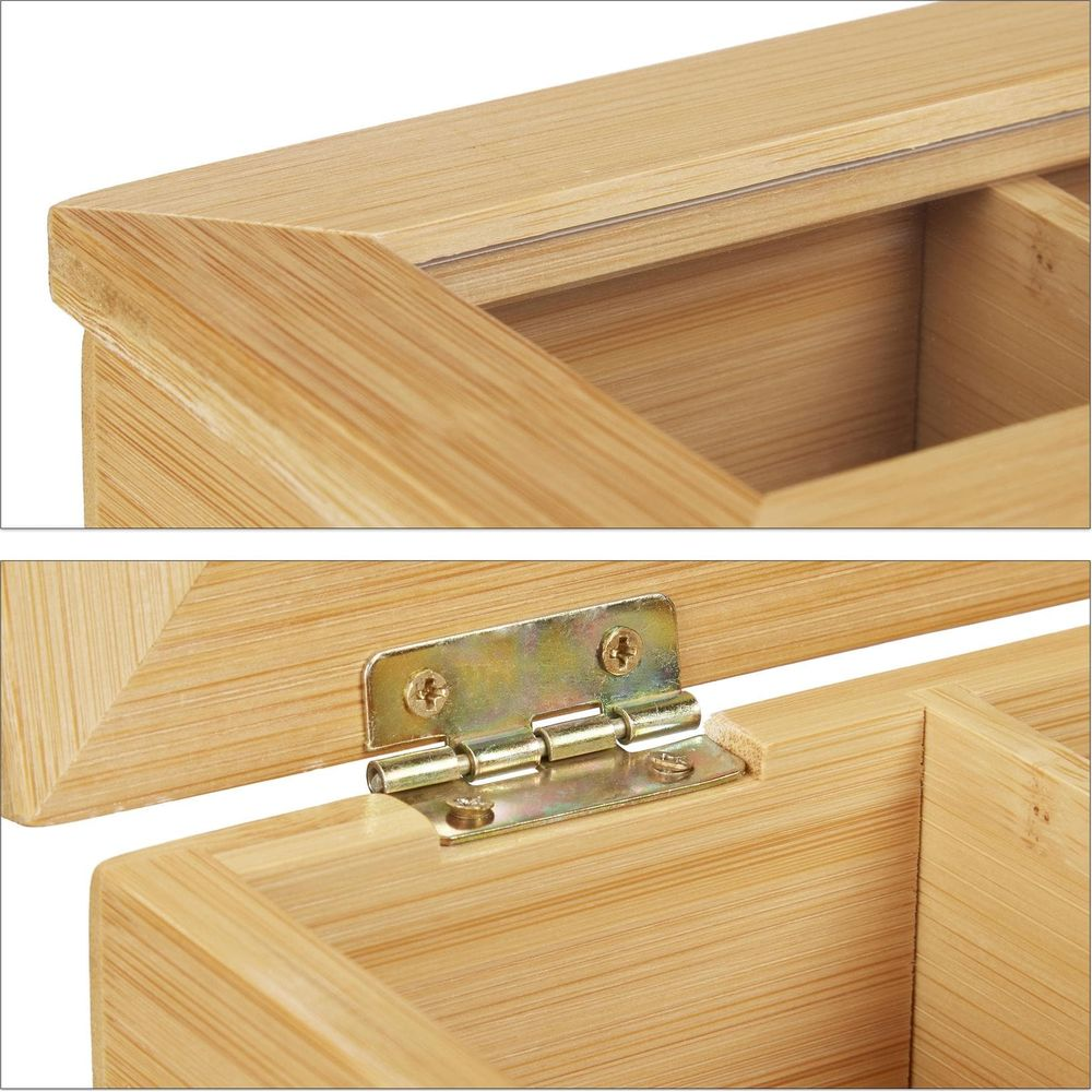 Nahaufnahme einer offenen Bambusbox mit Metallscharnieren und inneren Trennwänden.