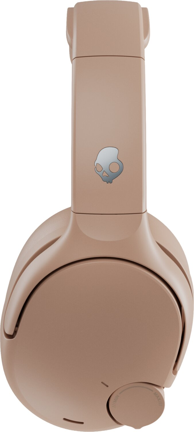 Auriculares supraurales en color beige con un logotipo plateado de calavera y una rueda de control.