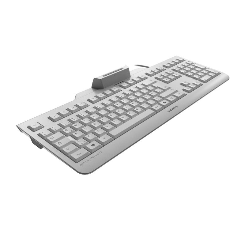 Un teclado gris Cherry con un lector de tarjetas integrado sobre una superficie blanca.