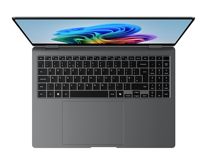 Draufsicht auf ein dunkelgraues Laptop mit beleuchtetem Bildschirm und farbigen Wellen sowie einer vollständigen Tastatur.