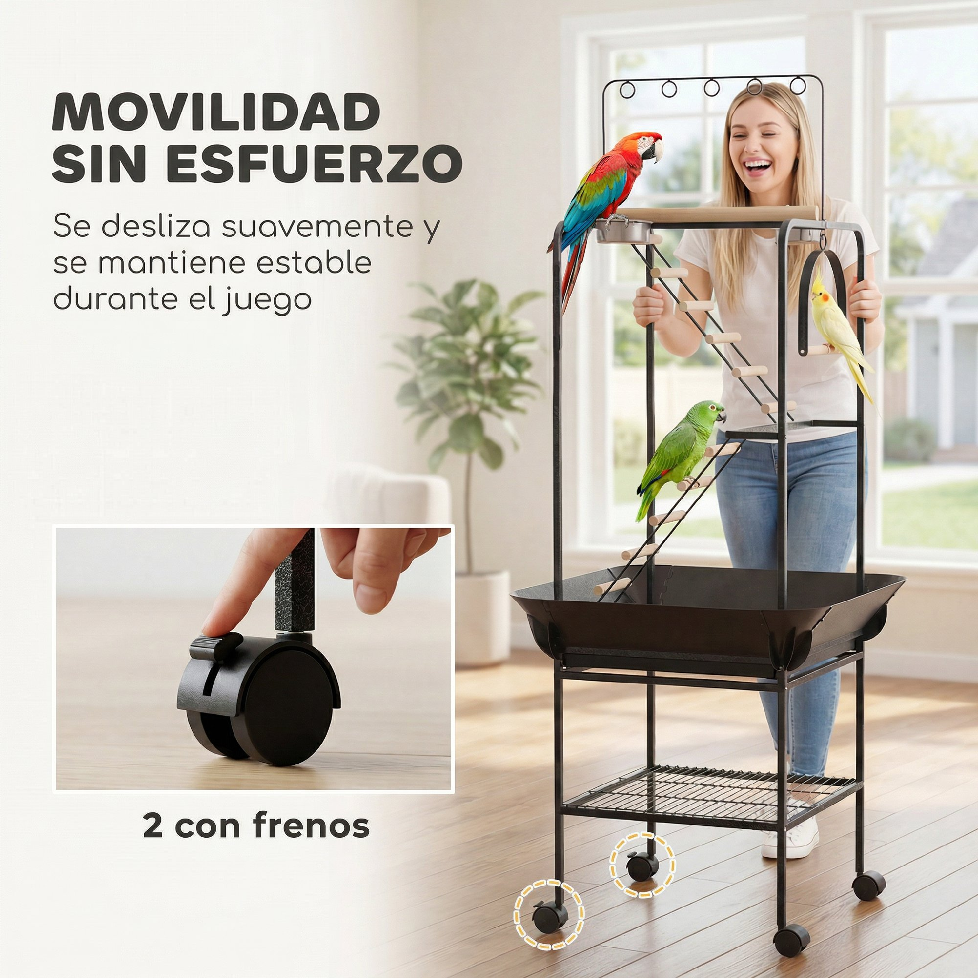 Una mujer sonríe junto a un parque para pájaros con ruedas y tres loros.