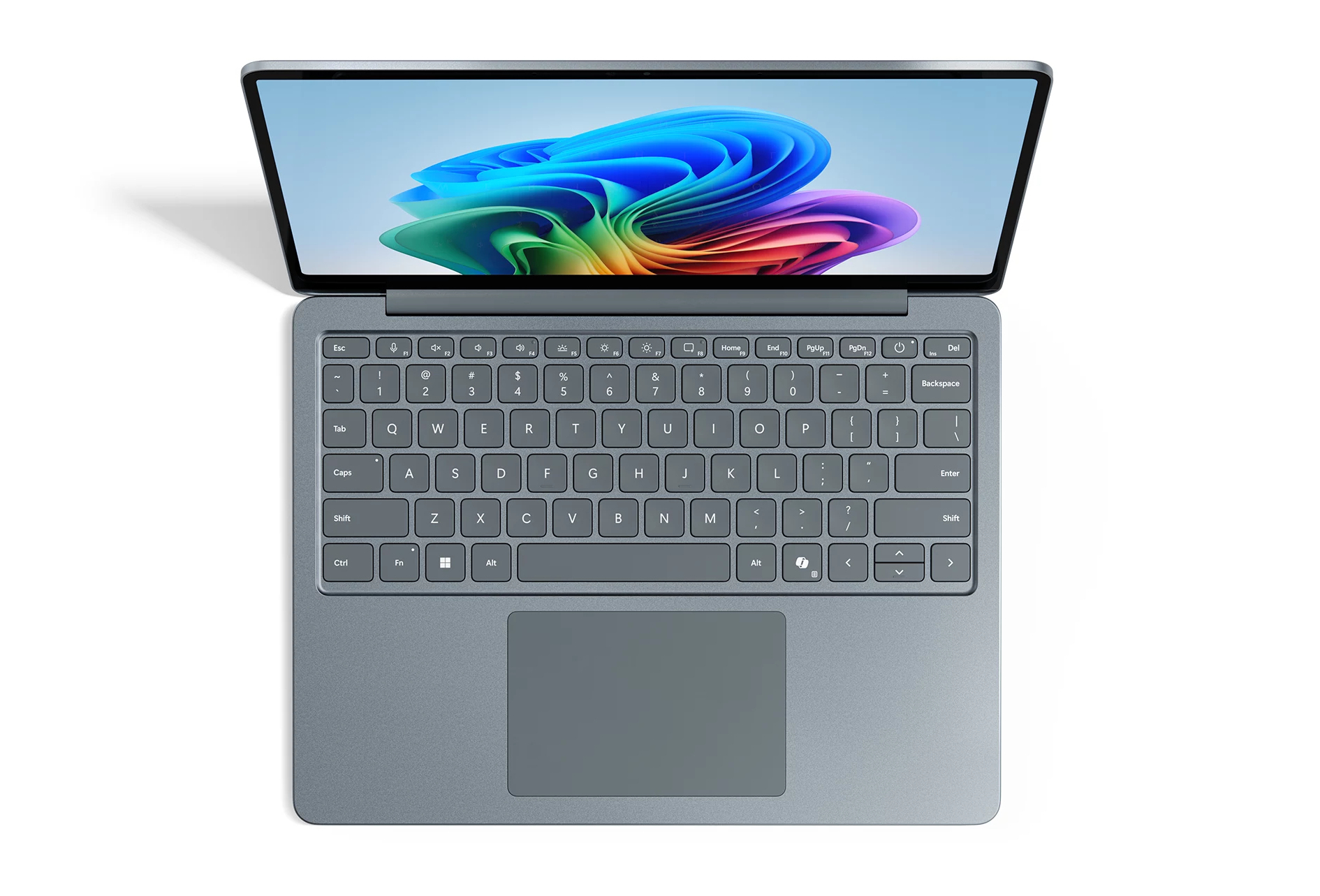 Top-down-Ansicht eines blauen Laptops mit farbigem Wellen-Hintergrundbild und deutscher Tastatur.