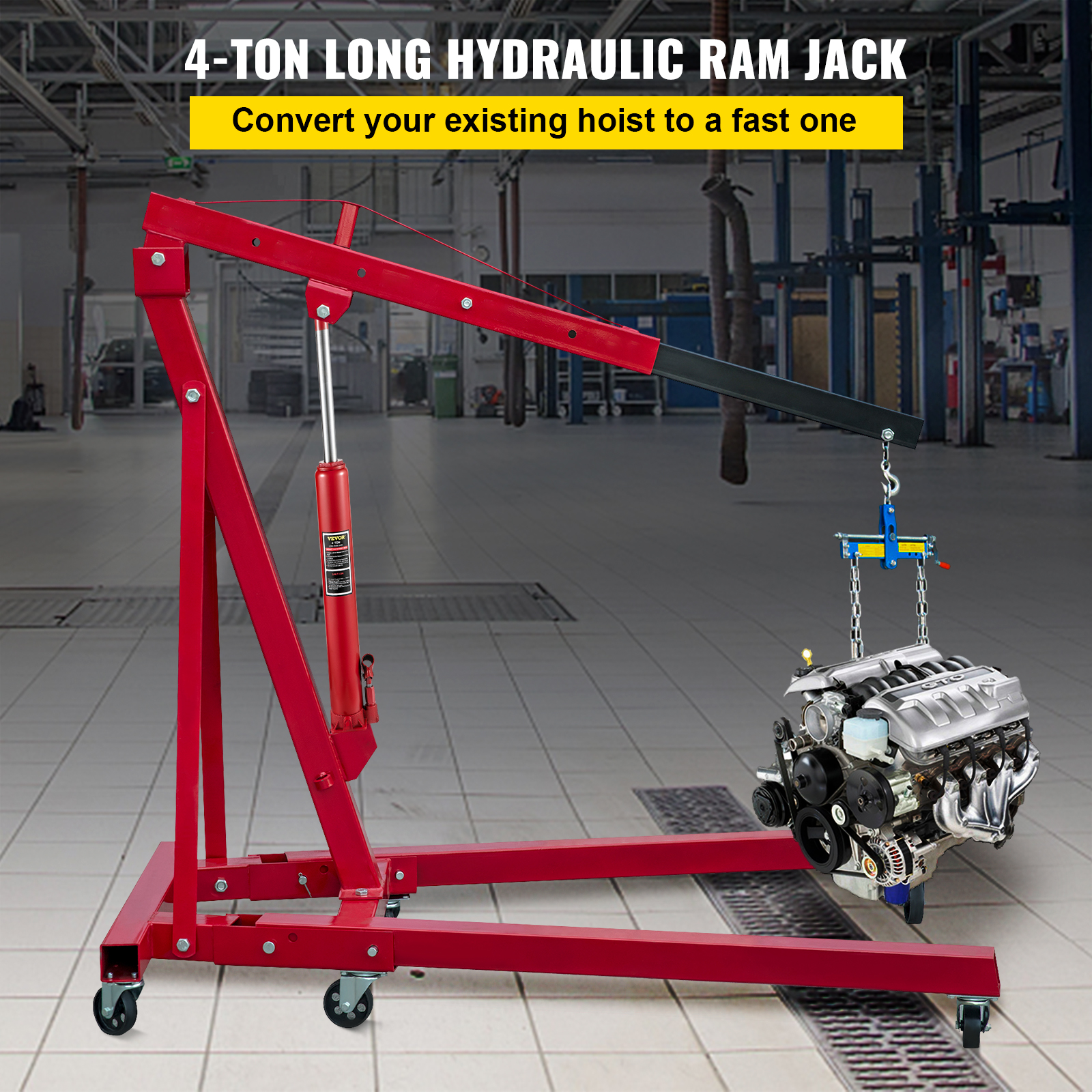 Una grúa hidráulica roja de 4 toneladas sostiene un motor en un taller.