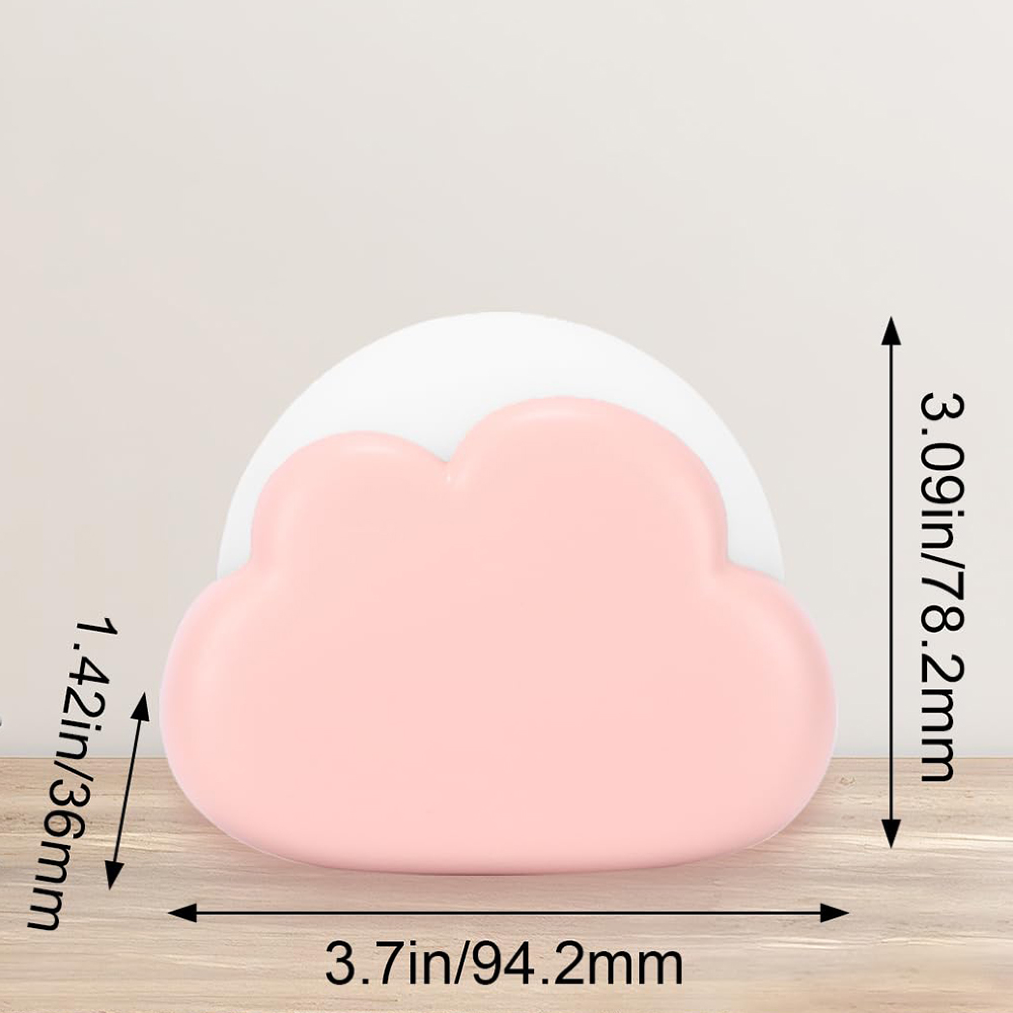 Ein rosafarbenes, wolkenförmiges Objekt auf einem Holztisch zeigt Abmessungen in Zoll und Millimetern.