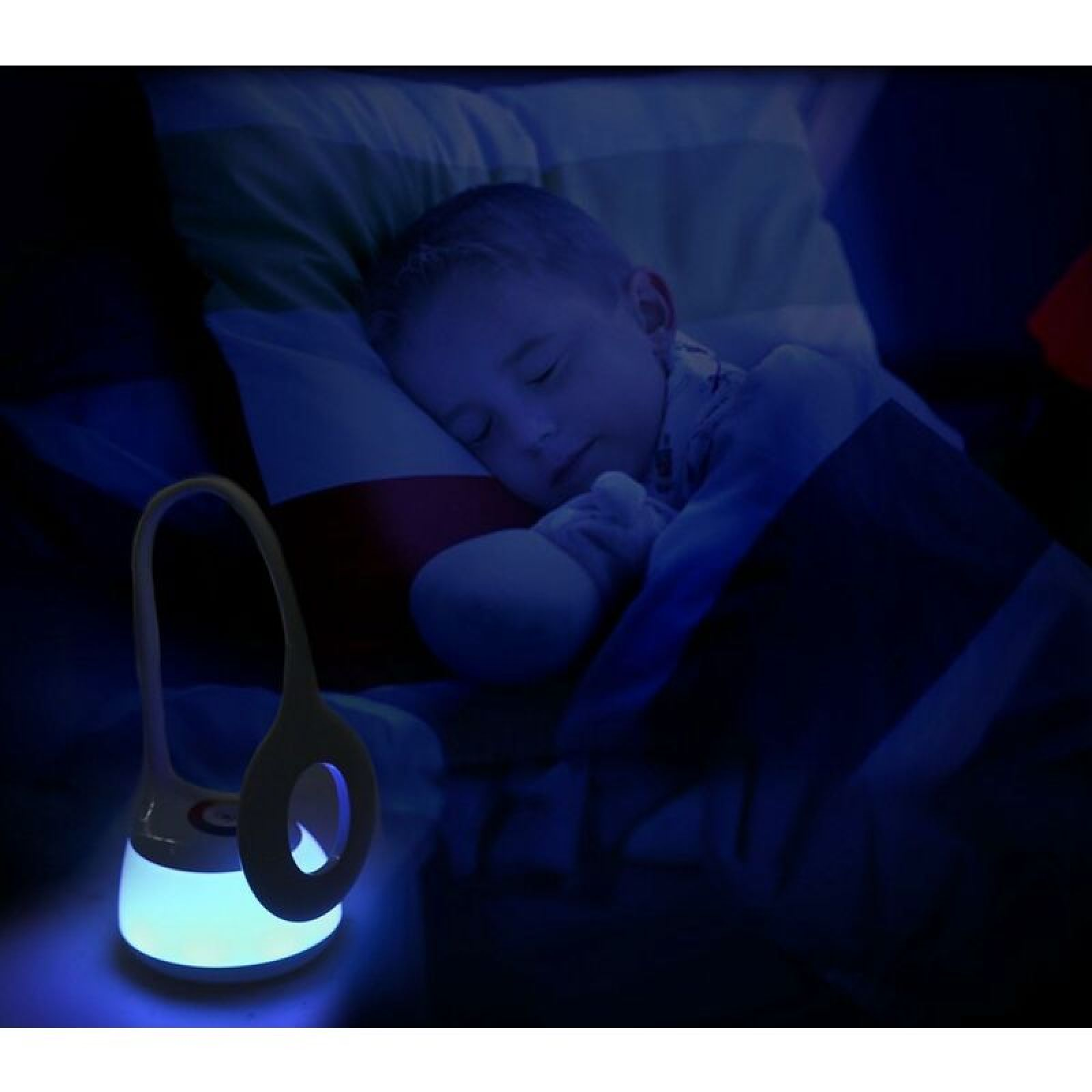 Ein Junge schläft friedlich in seinem Bett, beleuchtet vom sanften blauen Schein einer kleinen Nachtlampe.