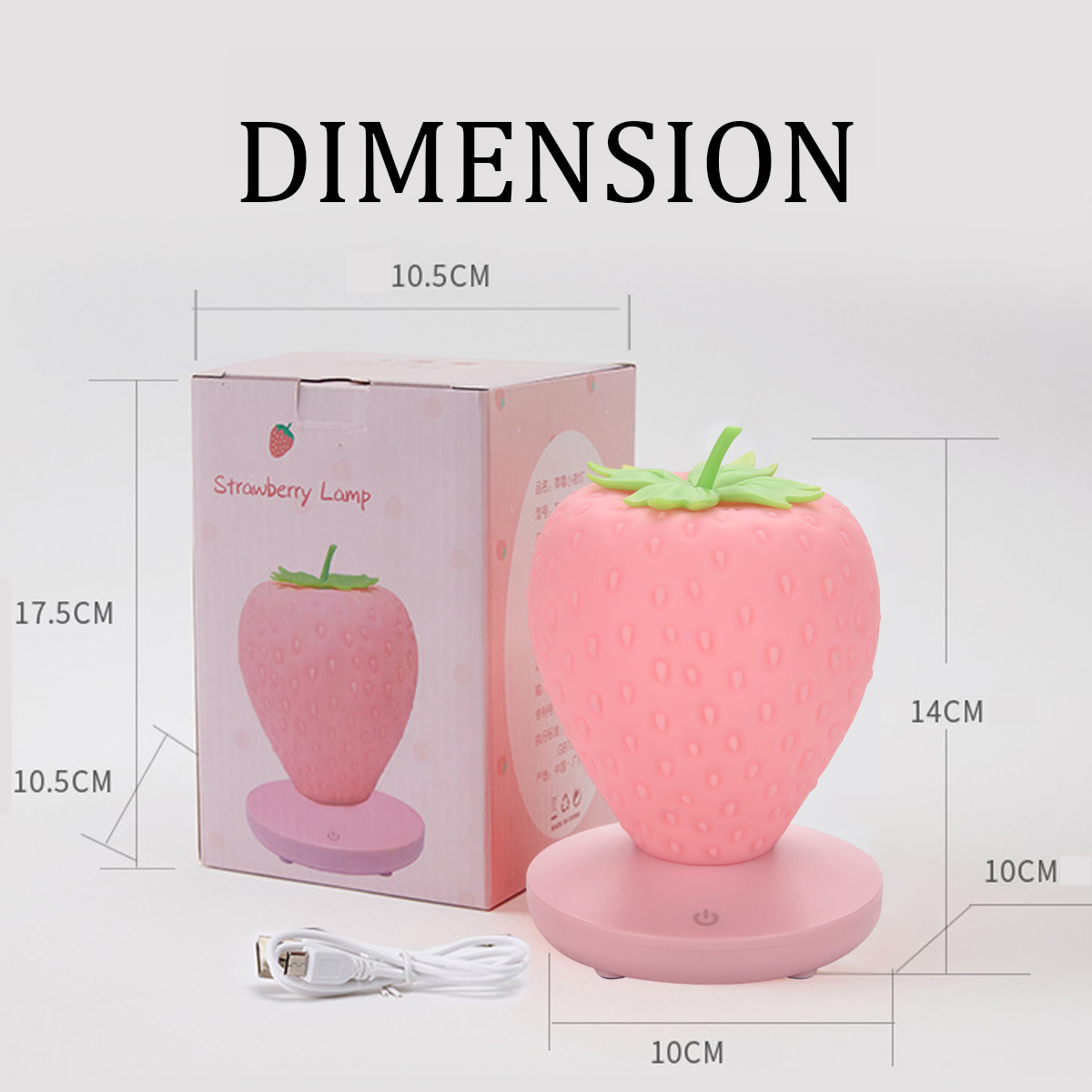 Rosa Erdbeerlampe auf Sockel, daneben die Verpackung und ein USB-Kabel, mit Maßangaben.