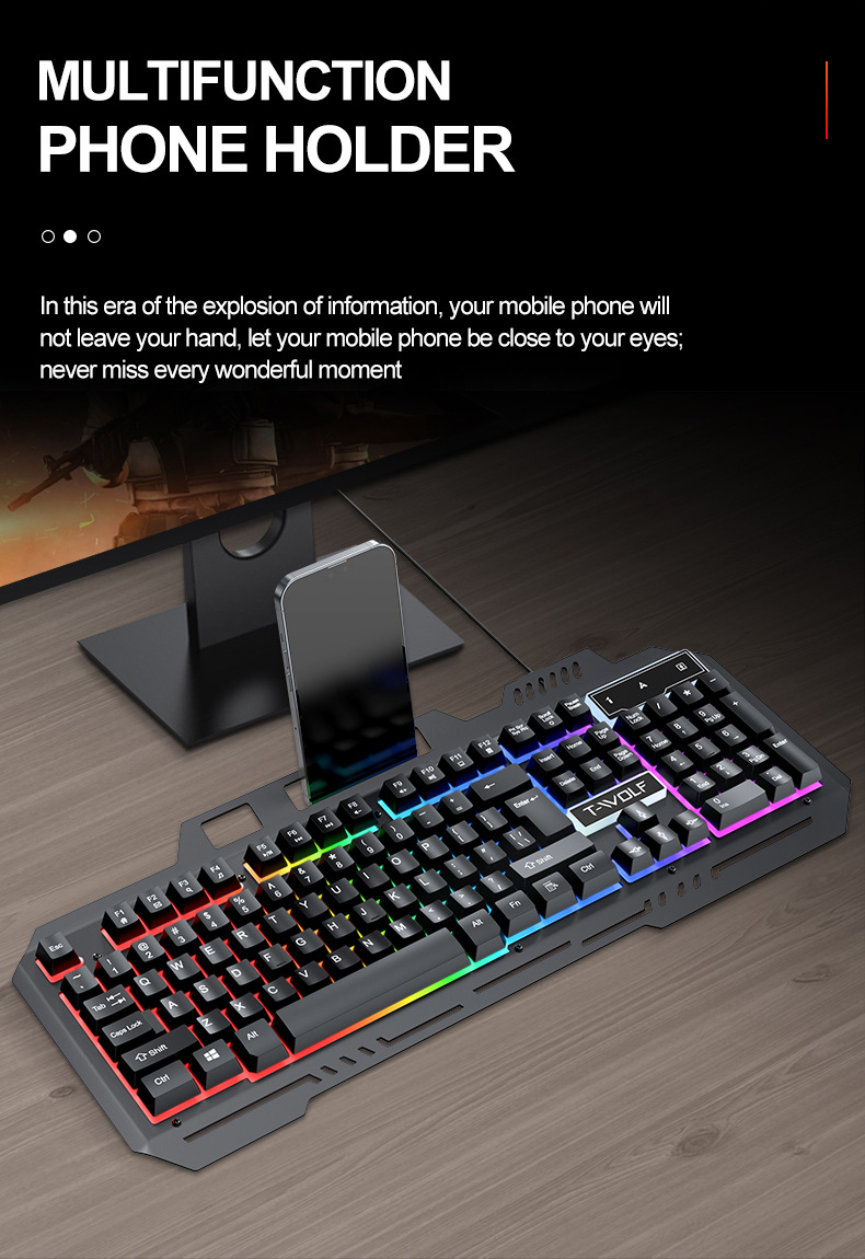 Eine schwarze RGB-Tastatur mit integriertem Handyhalter steht auf einem Holztisch und hält ein Smartphone.