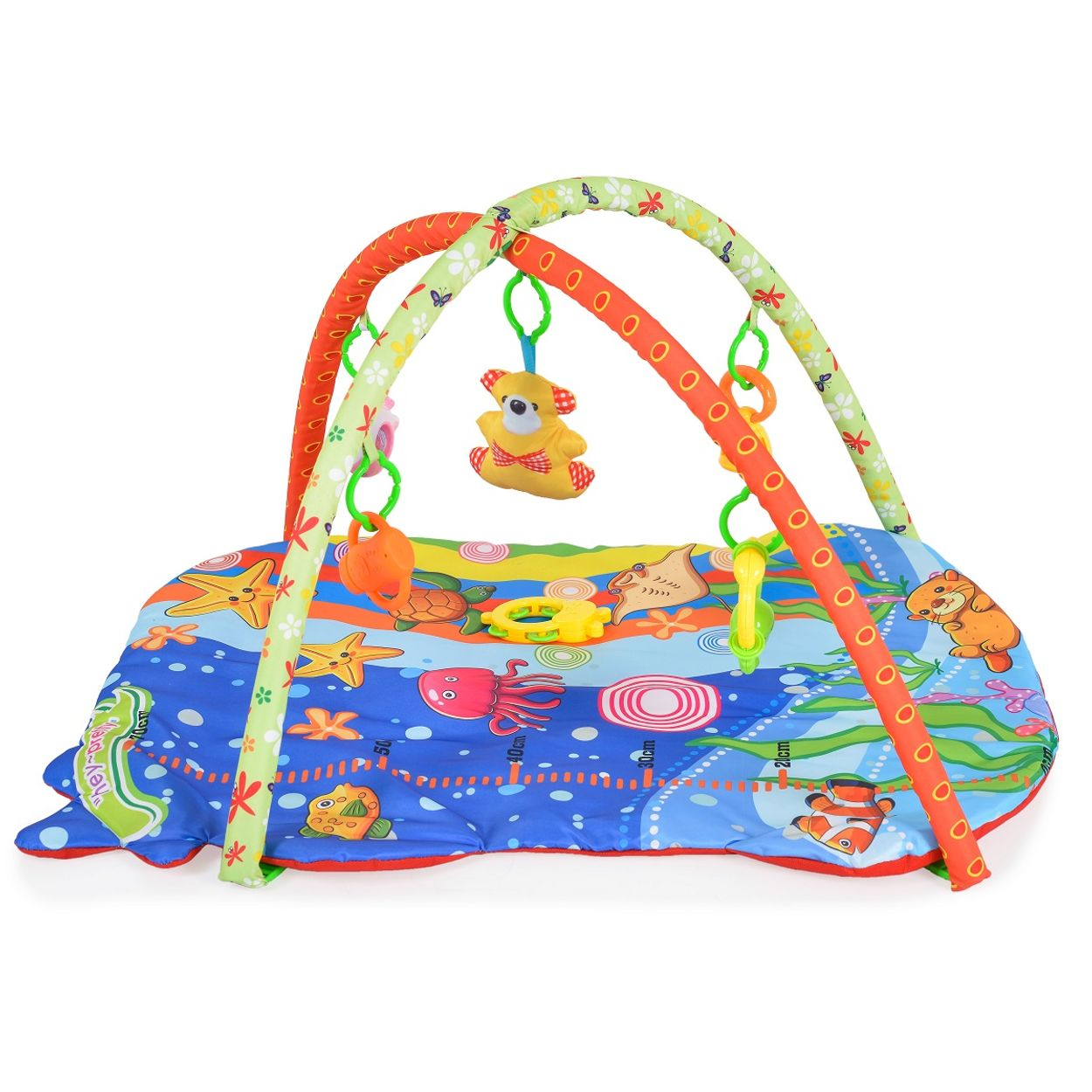 Buntes Baby-Spielkissen mit Ozeanmotiv und hängendem Plüschtier an gepolsterten Bögen.