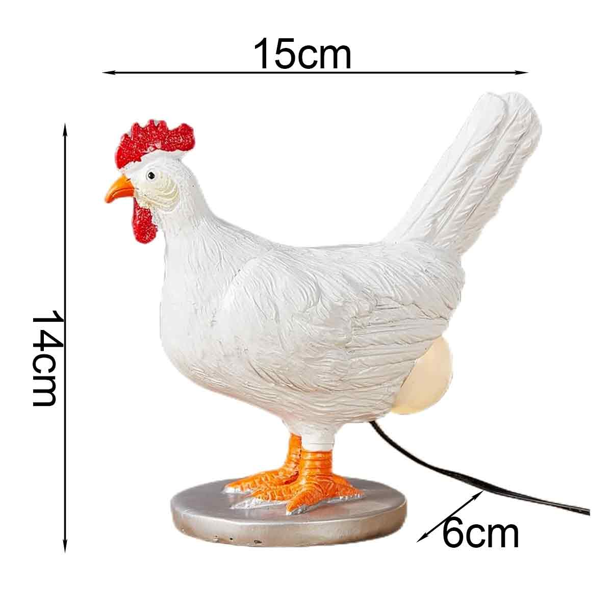 Weiße Hühnerlampe mit rotem Kamm, ein leuchtendes Ei legend, Maße 15cm breit, 14cm hoch, 6cm tief.