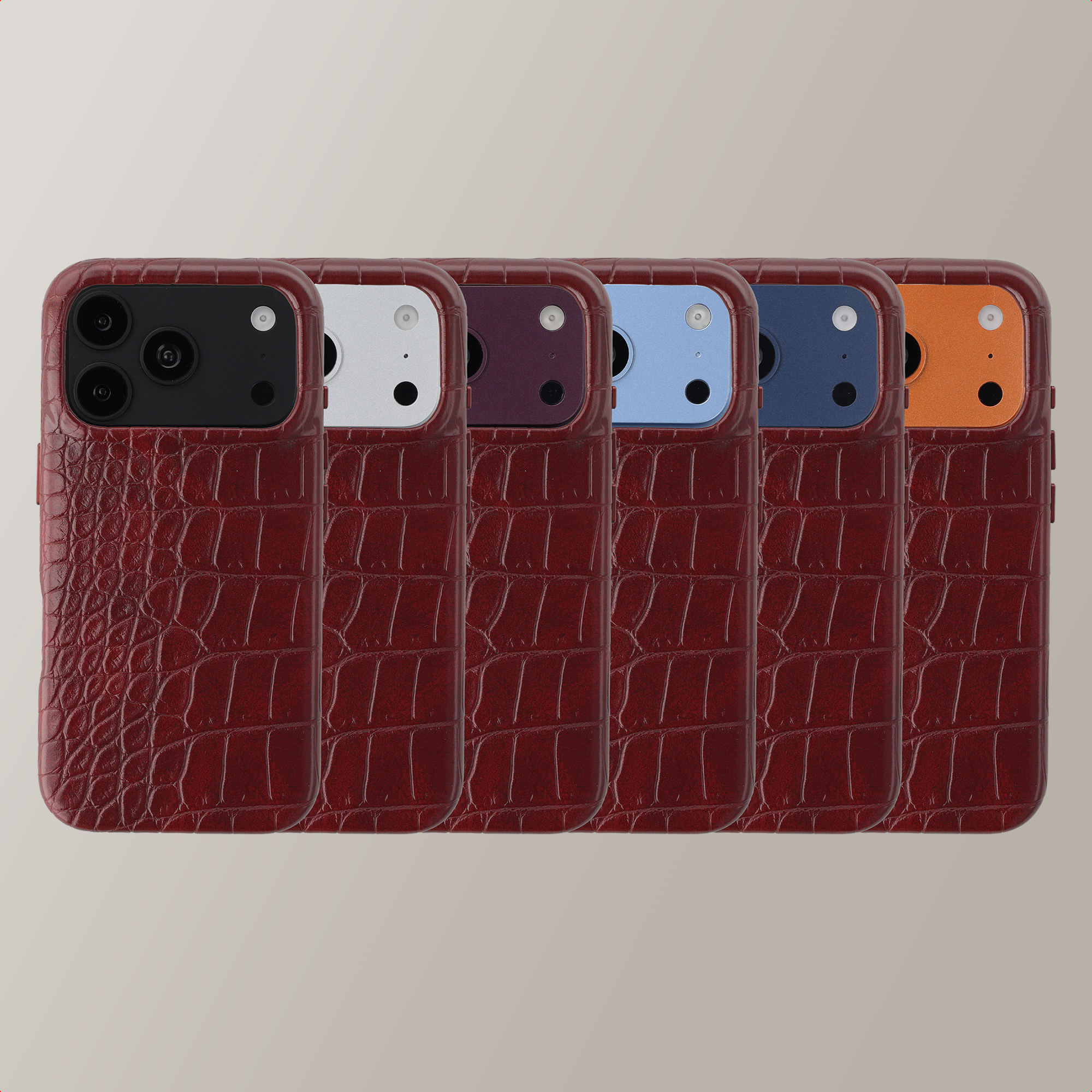 Zes smartphones met donkerrode krokodillenleren hoesjes en verschillende gekleurde cameramodules.