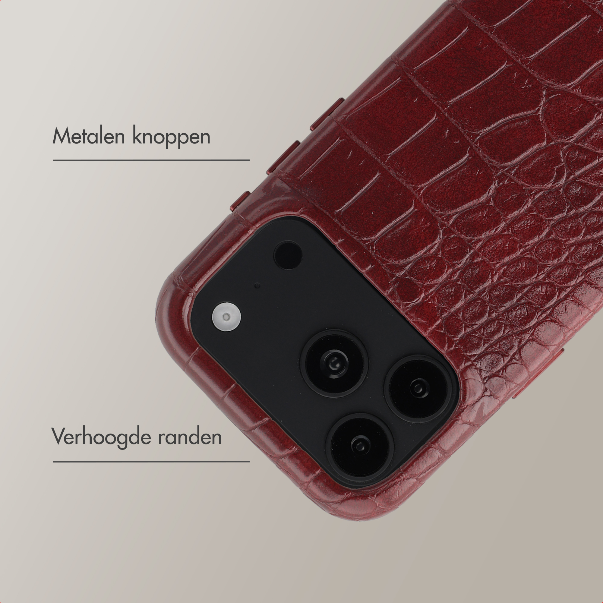 Donkerrode krokodillenstructuur telefoonhoesje met camera-uitsparing en tekst op neutrale achtergrond.