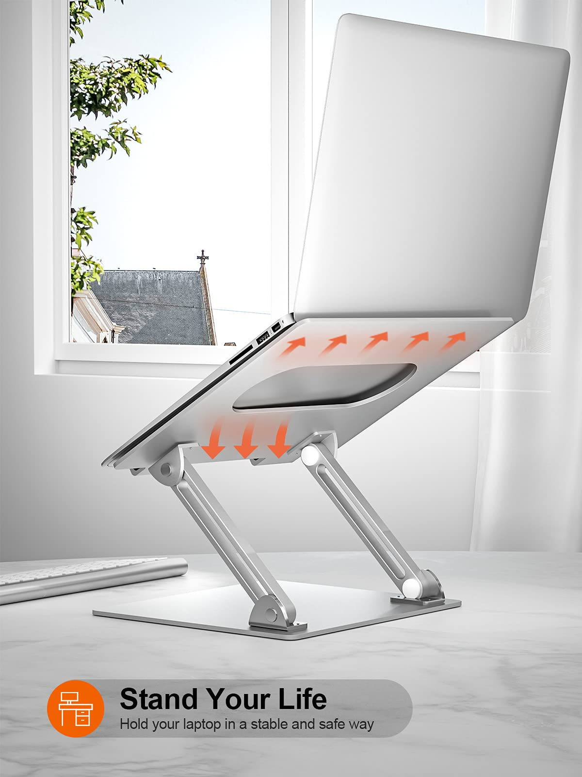 Ein silberner Laptopständer auf einem Tisch mit einem Laptop und orangen Pfeilen für die Belüftung.