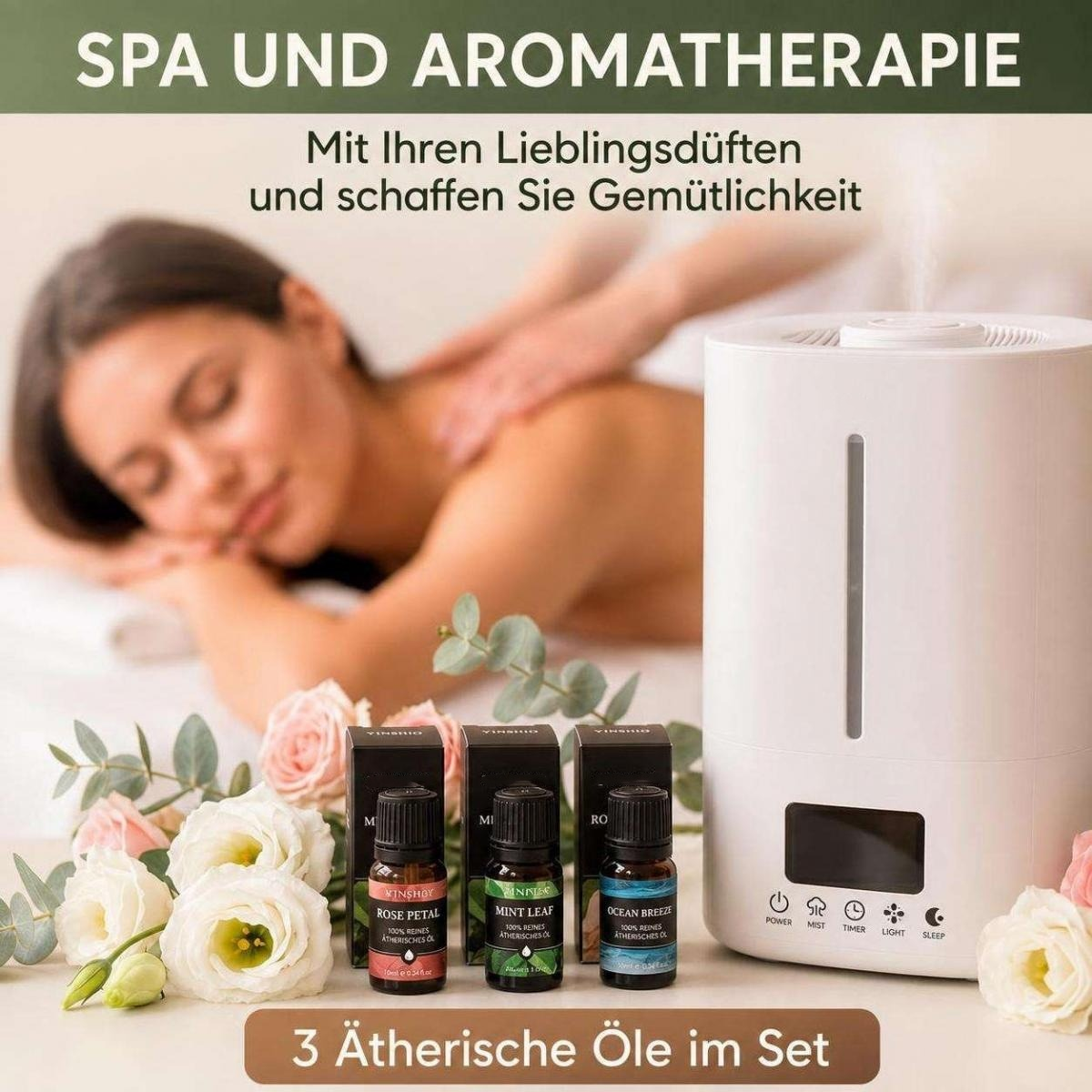 Ein weißer Diffusor und drei ätherische Öle stehen neben Blumen, während eine Frau im Hintergrund eine Massage erhält.