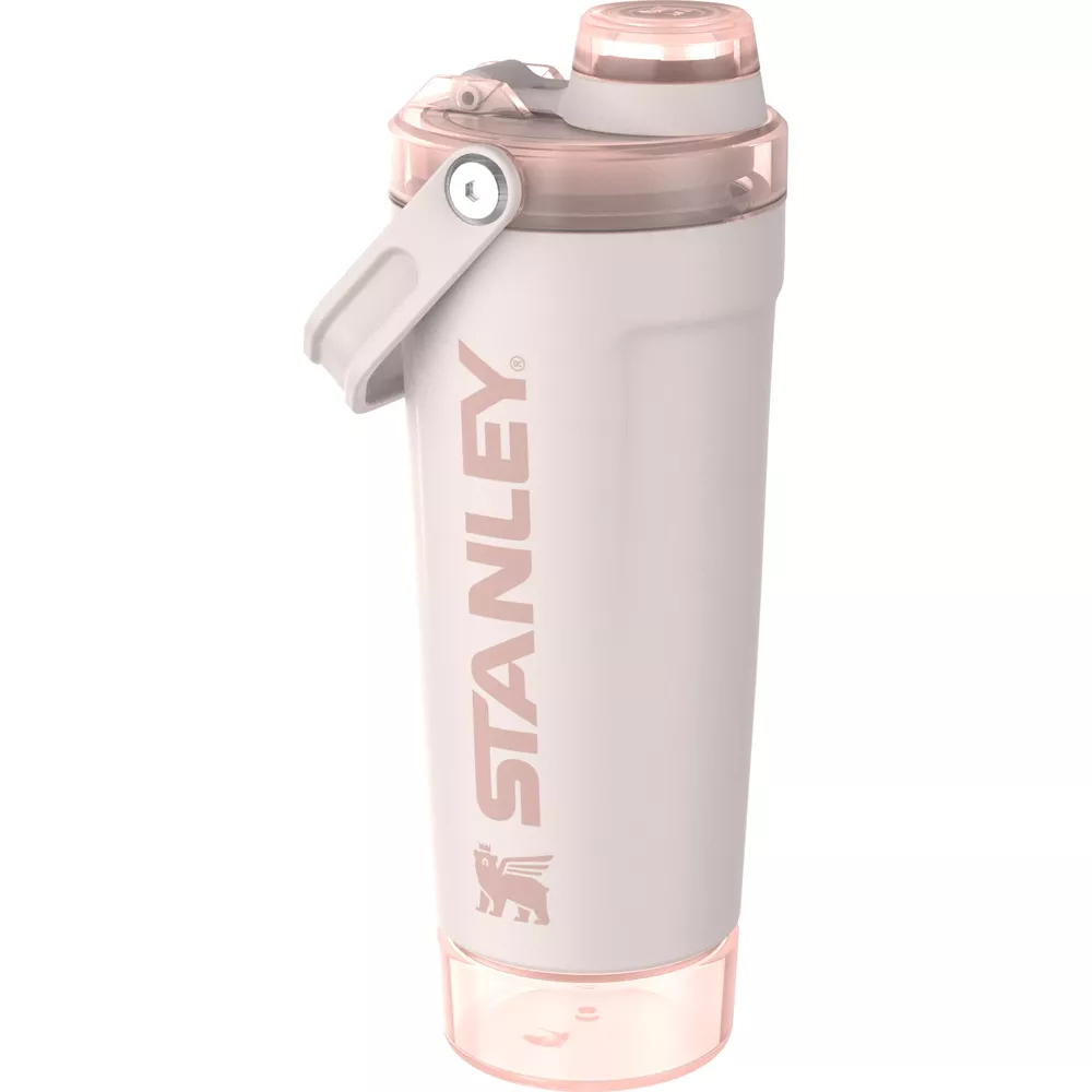 Beyaz arkaplanda şeffaf kapaklı, entegre saplı ve kabartma logolu açık pembe bir Stanley shaker şişesi.