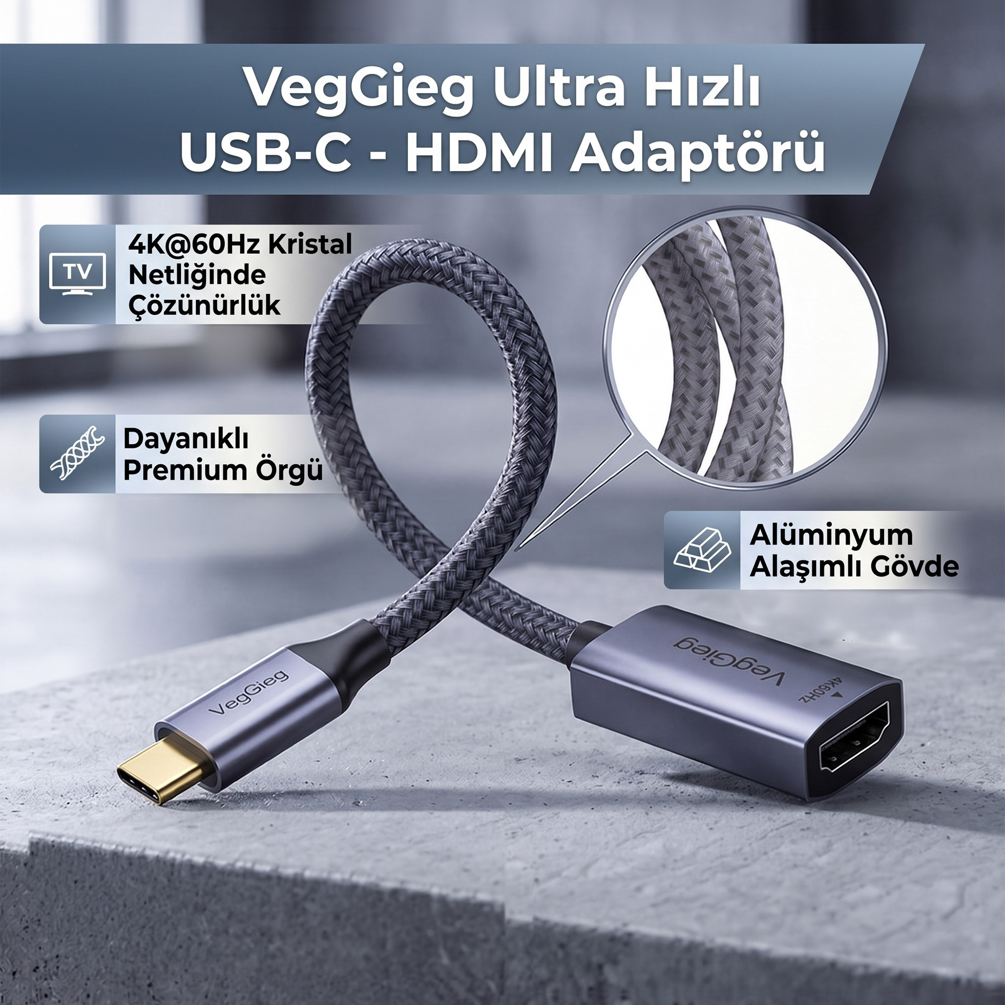 Gri taş üstünde örgü kablolu, yakın plan detaylı ve özellik simgeli gri USB-C - HDMI adaptörü.