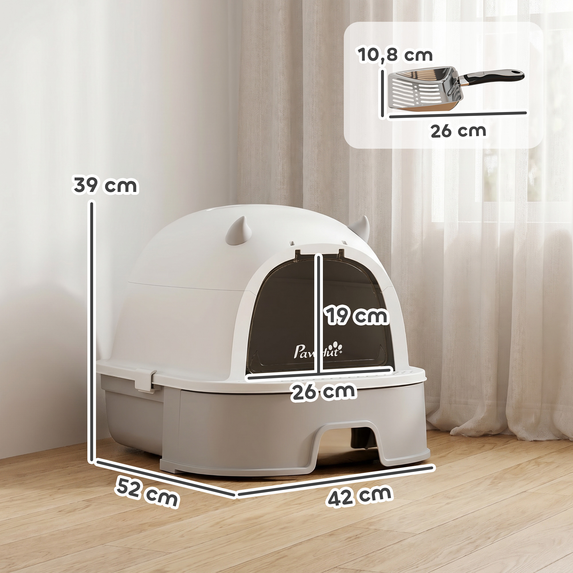 Caja de arena para gatos cubierta blanca con base gris, puerta y medidas en suelo de madera.