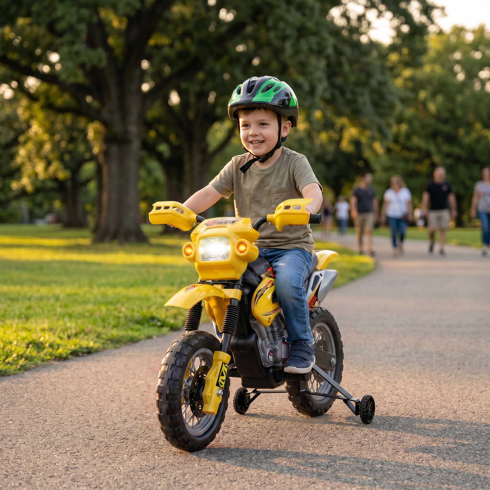 Un niño sonriente con casco monta en una moto de juguete amarilla en un parque.