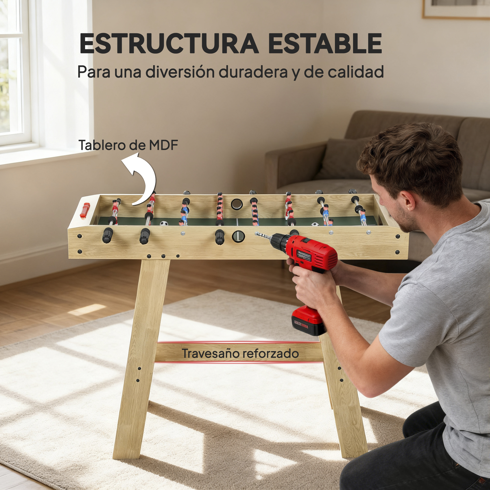 Un hombre usa un taladro inalámbrico rojo para armar un futbolín de madera.