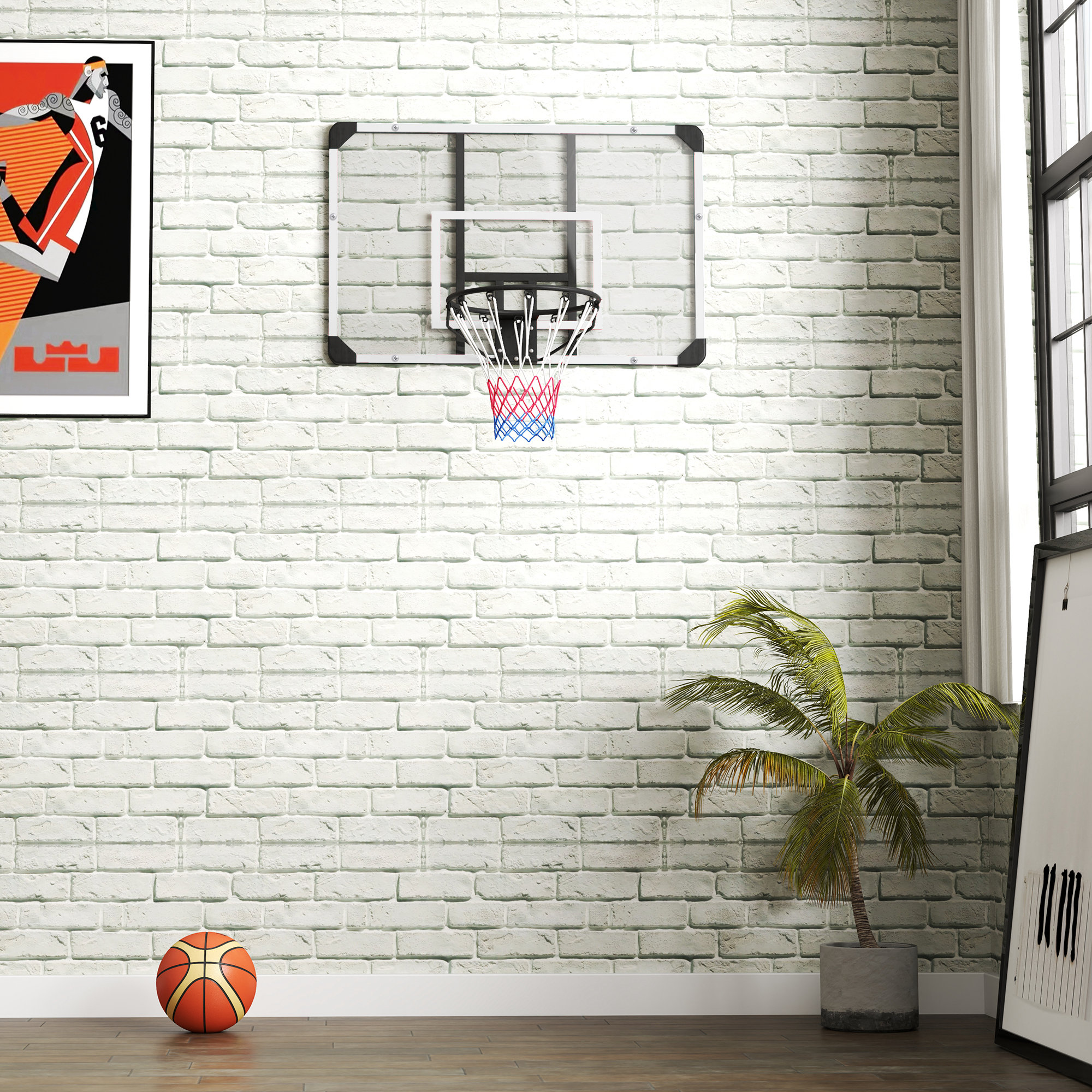 Una canasta de baloncesto en una pared de ladrillo blanco, con un balón, una planta y cuadros.