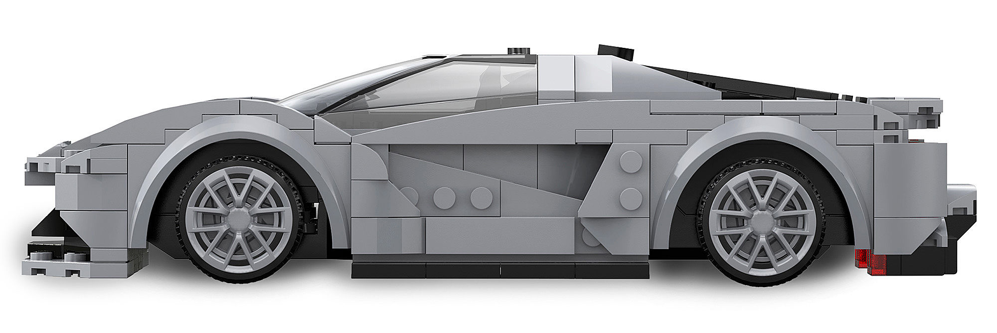 Ein graues Sportauto aus Lego Bausteinen im Seitenprofil auf weissem Hintergrund.