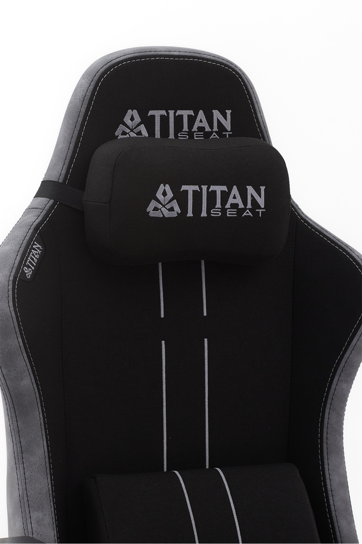 Beyaz arka planda kafalık ve gümüş logolara sahip siyah Titan Seat oyuncu koltuğu.