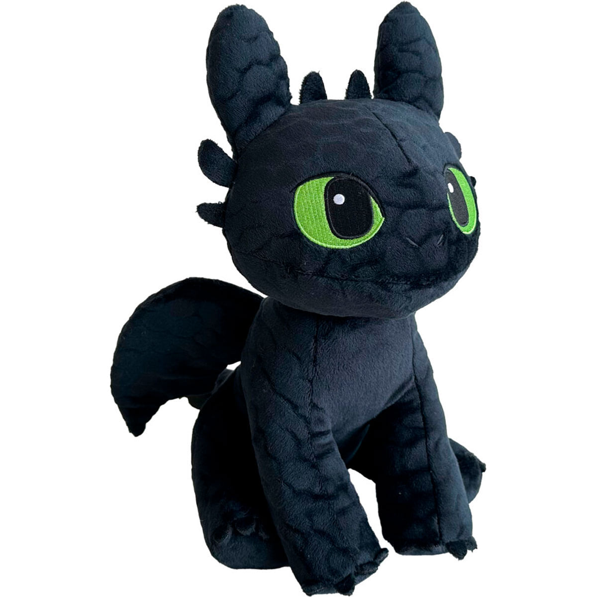 Un dragón de peluche negro con grandes ojos verdes, orejas puntiagudas y alas plegadas.
