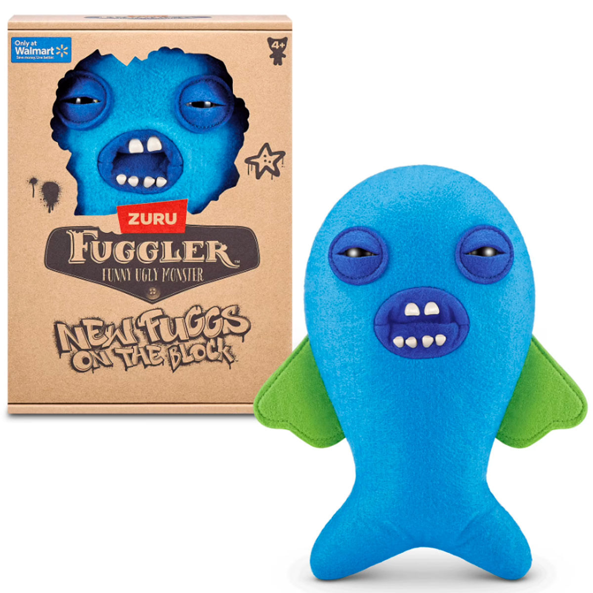 Un pez de peluche Fuggler azul con aletas verdes y dientes gruesos se encuentra junto a su caja.