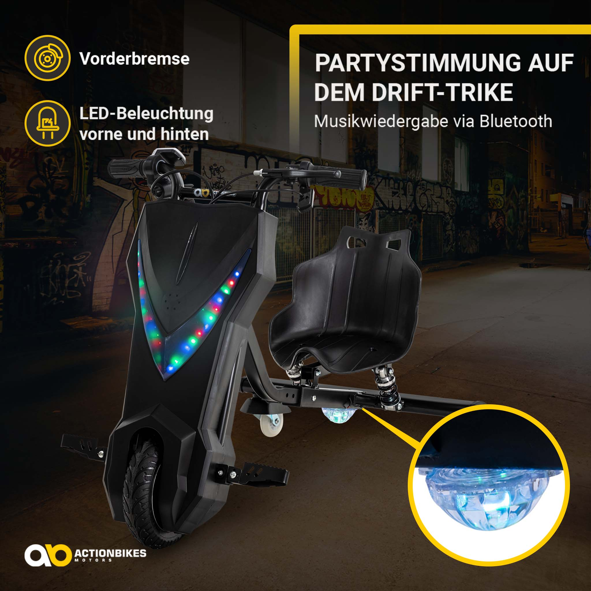 Schwarzes Drift-Trike mit bunten LED-Lichtern und Bluetooth-Musik, geparkt in einer urbanen Allee.