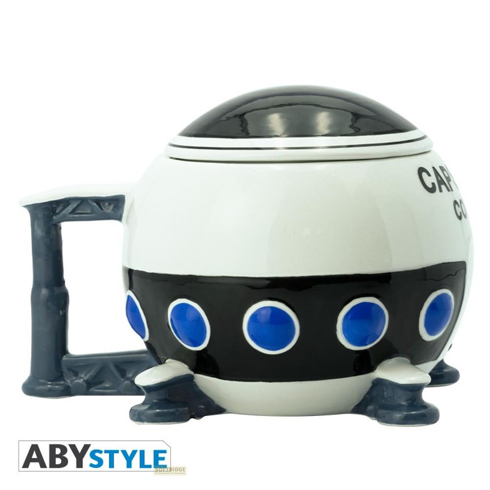Taza de cerámica redonda con forma de nave espacial, blanca y negra con ventanas circulares azules.