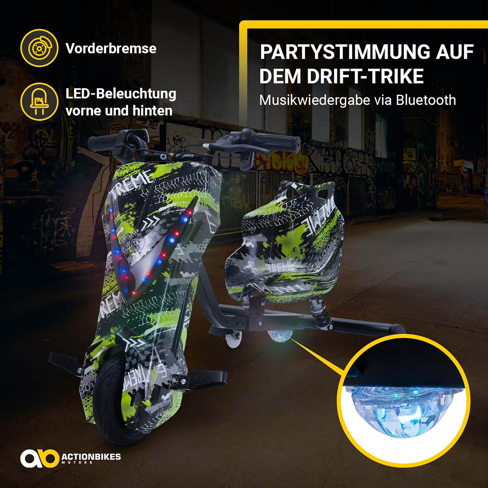 Ein grün-schwarz gemustertes Drift-Trike steht auf nächtlicher Straße mit LED-Beleuchtung und Bluetooth-Musik.
