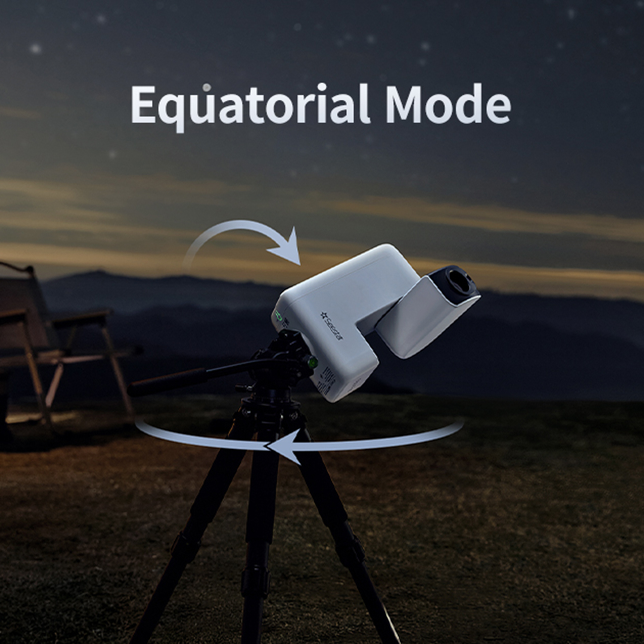 Un telescopio blanco en un trípode por la noche con montañas al fondo.