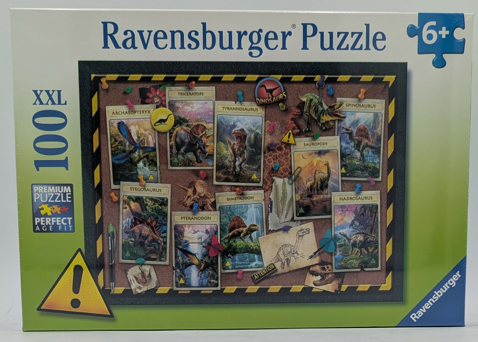 Puzzle di dinosauri Ravensburger XXL da 100 pezzi con carte su bacheca.