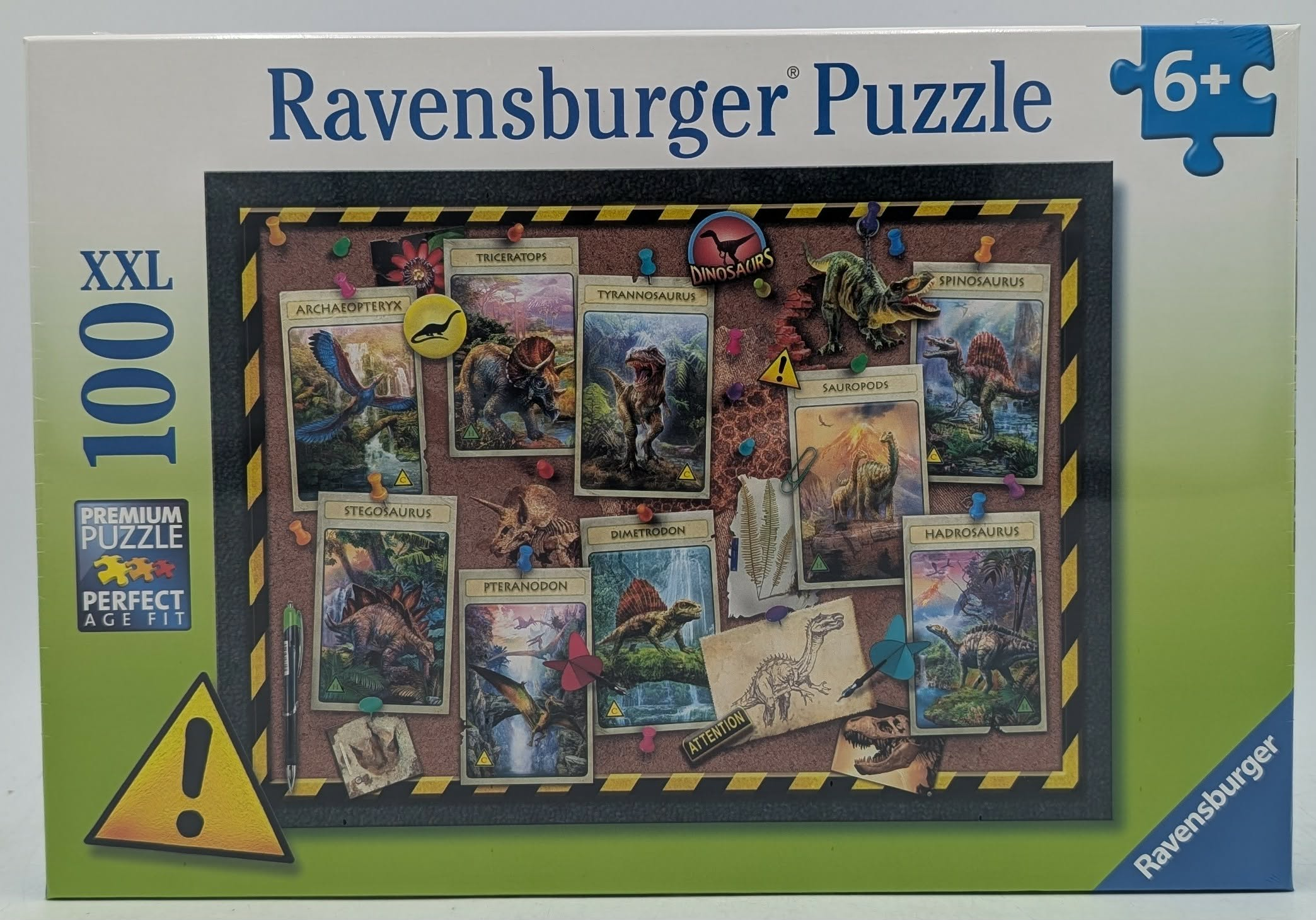 Una scatola di puzzle di dinosauri Ravensburger mostra una bacheca con varie carte di dinosauri.