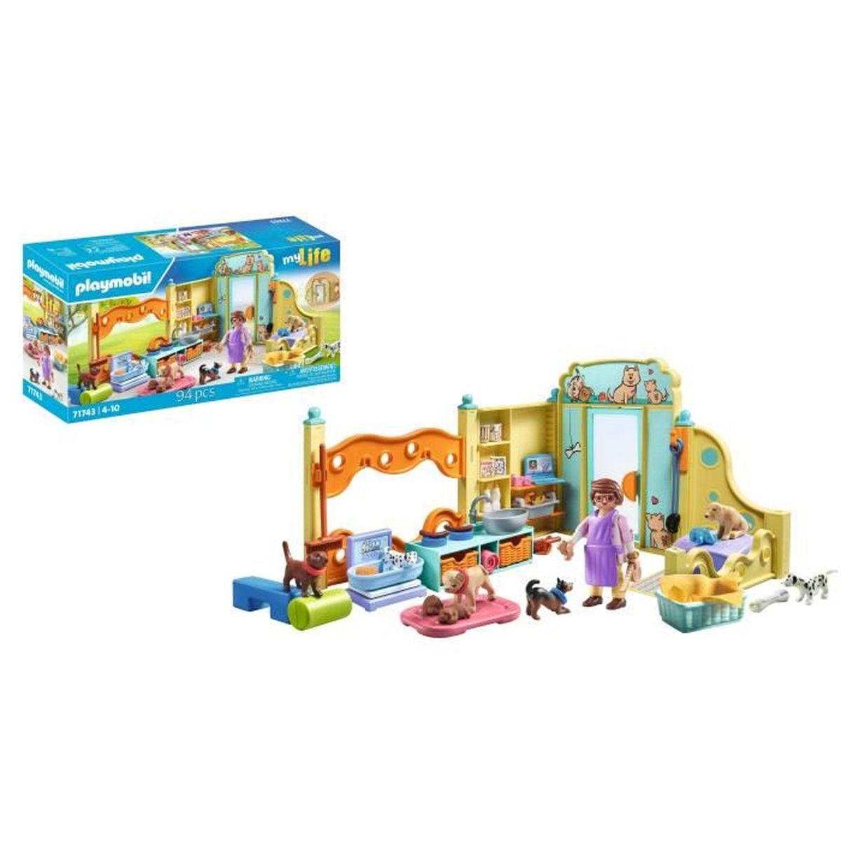 Set de juego Hotel de Mascotas Playmobil con una figura, varios perros y accesorios junto a su caja.